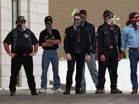 In this file photo from September of 1998, members of the Rock Machine wait outside a funeral home in St. Leonard where 60 people honoured the memory of gang co-founder Johnny Plescio. Now, nearly 20 years and a bloody gang war later, is the Rock Machine back? (Gazette/Pierre Obendrauf)