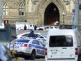 Police converge on Parliament Hill in Ottawa on Wednesday after a Canadian soldier standing guard at the National War Memorial was fatally shot.