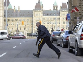 Police secure an area around Parliament Hill in Ottawa on Wednesday Oct. 22, 2014. A gunman opened fire at the National War Memorial, wounding a soldier, then moved to nearby Parliament Hill and wounded a security guard before he was shot, reportedly by Parliament's sergeant-at-arms.