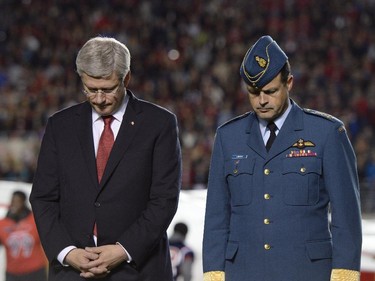 Prime Minister Stephen Harper participates in a tribute to the Canadian Forces, as well as fallen heroes Corporal Nathan Cirillo and Warrant Officer Patrice Vincent, before the start of CFL action between the Ottawa Redblacks and the Montreal Alouettes in Ottawa on Friday, Oct. 24, 2014.