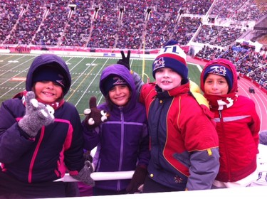 Triplets Nikki, Leah and Ela Harlton with their BFF Liam Lyons at Alouettes Game on Oct. 18, 2015. They are dressed for the season.