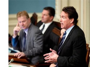 Quebec Opposition MNA Pierre Karl Peladeau, right, speaks during question period Wednesday at the legislature in Quebec City.