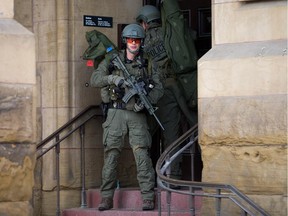 RCMP tactical officers attempt to enter the Langevin Block as police respond to the shooting in Ottawa on Wednesday, Oct. 22.