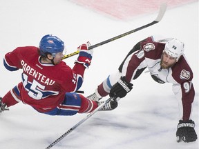 Canadiens' Pierre-Alexandre Parenteau (15) collides with Colorado Avalanche's Ryan O'Reilly during second period NHL hockey action in Montreal, Saturday, Oct. 18, 2014.