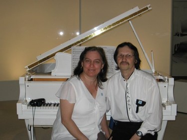 Shirley and Gary sitting at John Lennon's piano