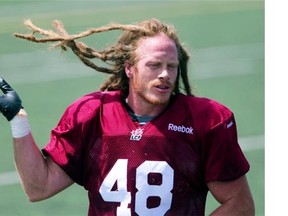 Montreal Alouettes linebacker Bear Woods, tosses his hair during the first day of the team's training camp, at Bishops University in Sherbrooke, east of Montreal, Sunday, June 1, 2014.