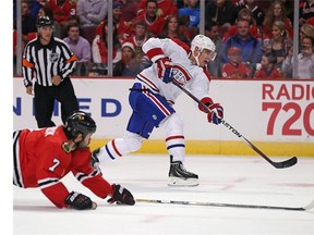 Rene Bourque of the Montreal Canadiens shoots the puck as Brent Seabrook of the Chicago Blackhawks dives for the attempted block during a preason game at the United Center on Oct. 1, 2014 in Chicago, Illinois. (Photo by Jonathan Daniel/Getty Images)