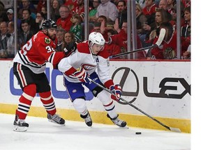 Lars Eller of the Montreal Canadiens controls the puck in front of Michal Rozsival of the Chicago Blackhawks during a preason game at the United Center on Oct.1, 2014 in Chicago, Illinois. (Photo by Jonathan Daniel/Getty Images)