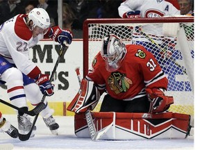 Chicago Blackhawks goalie Antti Raanta blocks the puck hit by Montreal Canadiens right wing Dale Weise during the first period of a preseason NHL hockey game in Chicago, Wednesday, Oct. 1, 2014. (AP Photo/Nam Y. Huh)