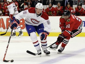 Montreal Canadiens left wing Drayson Bowman  controls the puck against Chicago Blackhawks centre Brad Richards during the first period of a preseason NHL hockey game in Chicago, Wednesday, Oct. 1, 2014.