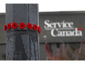 A dozen  poppies were placed  by a soldier on a lamp post in the parking lot a few feet from where one soldier was killed and an other  wounded in a hit and run. RCMP officials say they tried to press charges against Martin Couture Rouleau before the attack but were told they had insufficient evidence against him . (Marie-France Coallier/ THE GAZETTE).