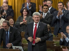 Canadian Prime Minister Stephen Harper rises in the House of Commons on Parliament Hill to vote for an air combat mission against ISIS on Tuesday, Oct. 7, 2014. Conservative MPs in the House of Commons have approved a motion to join the war in Iraq, clearing the way for Canadian CF-18s to take part in airstrikes in the Middle East.