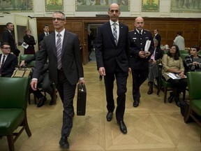 Minister of Public Safety and Emergency Preparedness Steven Blaney, CSIS Director Michel Coulombe and RCMP Commissioner Bob Paulson appear at the Commons National Security committee on Parliament Hill Wednesday October 8, 2014 in Ottawa.