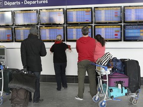 FILE — Travellers are standing in front of the departure board on Tuesday afternoon, January 7, 2014, at Trudeau airport.