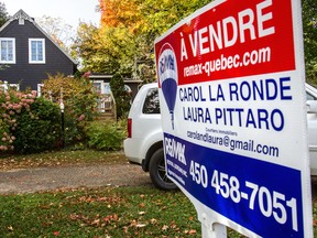 FILE — For sale signs in Hudson, Quebec on October 10, 2013.