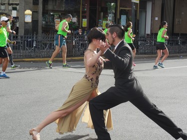 This photograph of a couple dancing tango on the main street of Buenos Aires, Argentina, was taken while a marathon was in progress.