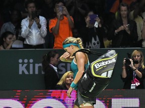 Westmount's Eugenie Bouchard leaves the court after being defeated by Serena Williams of the U.S. during the WTA Finals  in Singapore on Oct. 23, 2014.