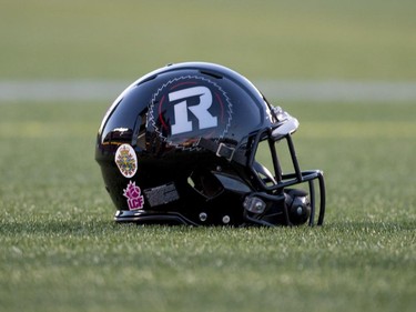 The emblem of the Canadian Armed Forces is seen on the helmet an Ottawa Redblacks player before a CFL game, in tribute to the two fallen Canadian Armed Forces members, Warrant Officer Patrice Vincent and Cpl. Nathan Cirillo, in Ottawa on Friday, Oct. 24, 2014.