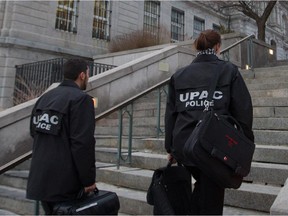 Members of the UPAC anti-corruption squad arrive at Montreal city hall Feb. 19, 2013.