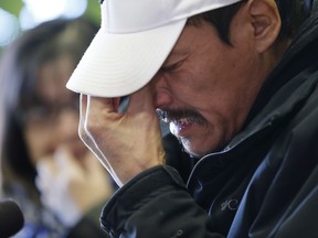 Caesar Harper, father of Rinelle Harper, weeps at a press conference in Winnipeg, on Thursday.