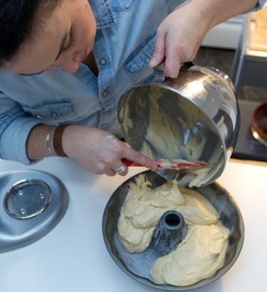 Liz Vargas pours batter in a bundt cake form to make her rum cake in Montreal Tuesday, November 4, 2014. The Montreal woman has started a business dedicated to making her Azucar & Ron rum cakes.