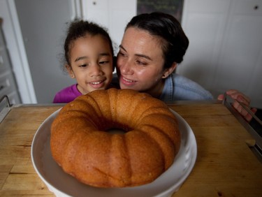 Liz Vargas with  her daughter Layla with her rum cake in Montreal Tuesday, November 4, 2014. The Montreal woman has started a business dedicated to making her Azucar & Ron rum cakes.