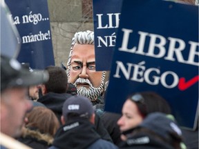 A a man wearing a giant head in the likeness of Quebec Premier Philippe Couillard attends a protest at the Robert Guertin Arena as Quebec municipal workers across the province, including Gatineau, stage a one day strike on pension plan changes.