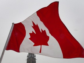 A Canadian flag flies near the Peace tower on Parliament Hill in Ottawa on Feb.15, 2012.