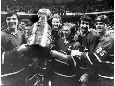 A group of happy Montreal Canadiens celebrate with a late 1970s Stanley Cup won over the Boston Bruins at Boston Garden. From left: Serge Savard, Gilles Lupien, Mario Tremblay, Larry Robinson, Yvan Cournoyer, Guy Lapointe, Jacques Lemaire.