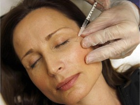 A woman has Botox injected in Arlington, Va. on Friday, June 5, 2009.