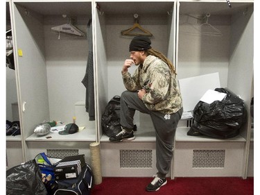 Montreal Alouettes linebacker Bear Woods (48) pauses as the team clears out their lockers Monday, Nov. 24, 2012 in Montreal. The Hamilton Tiger-Cats defeated the Alouettes 40-24 to advance to the Grey Cup game in Vancouver.