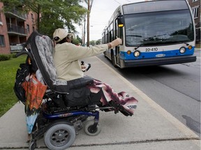 A woman flashes her bus pass as the number 108 bus in Verdun.