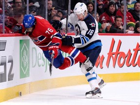The Winnipeg Jets' Bryan Little checks the Canadiens' P.K. Subban into the boards during NHL game at the Bell Centre on Feb. 2, 2014.