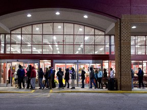 Shoppers wait in freezing temperatures to get their holiday shopping season going at the annual Black Friday sales event at the Sports authority store November 28, 2014 in Greenfield, Wisconsin.