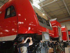 Workers assemble double decker passenger cars at a Bombardier factory in Germany in 2009.