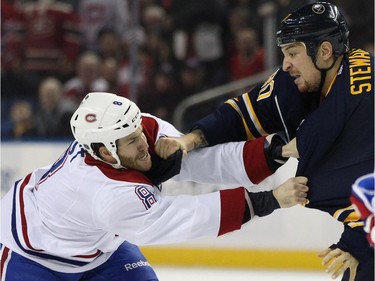 Montreal Canadiens left winger Brandon Prust (8) and Buffalo Sabres right winger Chris Stewart (80) grab one another in a first-period fight during an NHL hockey game Friday, Nov. 28, 2014, in Buffalo, N.Y.  Buffalo won 2-1.