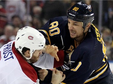 Montreal Canadiens left winger Brandon Prust (8) tries to defend himself against the grip of Buffalo Sabres right winger Chris Stewart (80) during a fight in the first period of an NHL hockey game Friday, Nov. 28, 2014, in Buffalo, N.Y.  Buffalo won 2-1.