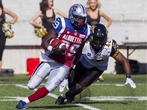 Montreal Alouettes Brandon Rutley, left, is chased down by Hamilton Tiger-Cats linebacker David Caldwell in Hamilton, Ont., on June 14, 2014. Rutley's patience is being rewarded. The running back will start Sunday when the Montreal Alouettes face the B.C. Lions in the East Division semifinal.