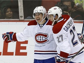 Montreal Canadiens right wing Brendan Gallagher, left, celebrates his goal against the Detroit Red Wings with Alex Galchenyuk (27) in the third period of an NHL hockey game in Detroit Sunday, Nov. 16, 2014.