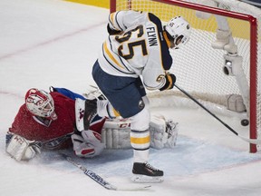 Buffalo Sabres' Brian Flynn scores against Montreal Canadiens goaltender Dustin Tokarski during shootout NHL hockey action in Montreal, Saturday, November 29, 2014.