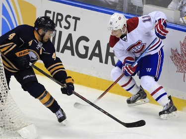 Buffalo Sabres' Josh Gorges knocks the puck away from Montreal Canadiens' Brendan Gallagher during the second period on Wednesday, Nov. 5, 2014, in Buffalo, N.Y.