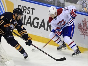 Sabres defenceman Josh Gorges knocks the puck away from Canadiens forward Brendan Gallagher during game in Buffalo on Nov. 5, 2014.