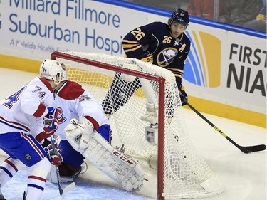 Buffalo Sabres' Matt Moulson looks to make a pass around the Montreal Canadiens net during the first period on Wednesday, Nov. 5, 2014, in Buffalo, N.Y. Defending for the Canadiens are Alexei Emelin (74) and Dustin Tokarski.