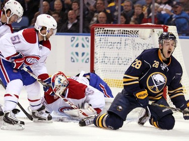 Buffalo Sabres' Zemgus Girgensons reacts after his shot was blocked by Montreal Canadiens' Dustin Tokarski and David Desharnais (51) during the first period on Wednesday, Nov. 5, 2014, in Buffalo, N.Y.