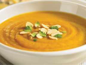 Butternut and chestnut soup is trimmed with sliced nuts and parsley.