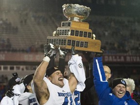 Montreal Carabins' Byron Archambault and head coach Danny Maciocia hoist the Vanier Cup after beating the McMaster Marauders in the CIS football final in Montreal Saturday, November 29, 2014.