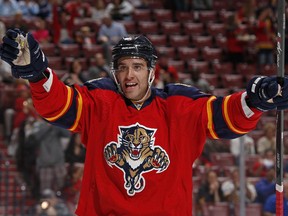 Aaron Ekblad celebrates after a Panthers goal in front of a lot of empty seats in Florida for a game against the Calgary Flames on Nov. 8, 2014.