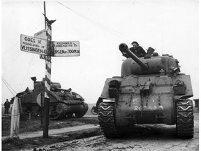 Canadian tanks on the move in Holland in 1945.  The final operations in the west began with the Rhine crossing in the British area on March 23. After this, the 1st Canadian Army, still on the left of the line, liberated east and north Netherlands. (Canadian Army Photo - Crown Copyright Reserved  1945)