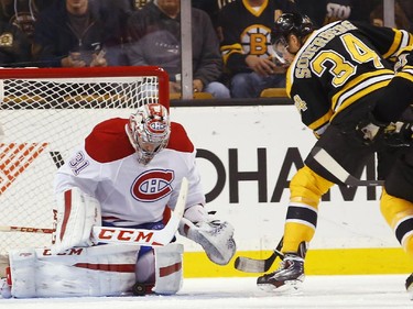Montreal Canadiens goalie Carey Price, left, makes a save as Boston Bruins' Carl Soderberg (34) and Patrice Bergeron look for the rebound during the third period of Montreal's 2-0 win in an NHL hockey game in Boston Saturday, Nov. 22, 2014.