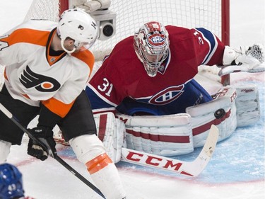 Montreal Canadiens goalie Carey Price makes a save off Philadelphia Flyers' Sean Couturier during the second period of their NHL hockey game in Montreal on Saturday, Nov. 15, 2014.
